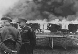 Buildings of the Bergen-Belsen concentration camp are burned to the ground by British soldiers to prevent the spread of typhus. Germany, May 21, 1945.