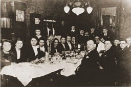 A large family group celebrates the Passover seder. Lodz, Poland, ca. 1938-1939.