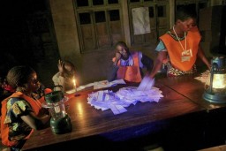 Election officers count votes late into the night after the second round of the 2006 presidential and provincial elections in Bunia, Ituri, Democratic Republic of the Congo. 