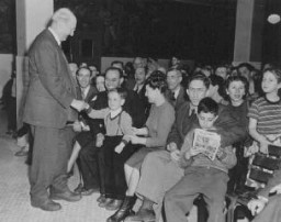 Henry Morgenthau, Jr., treasury secretary in the Roosevelt administration and later chairman of the United Jewish Appeal, greets Jewish refugees en route from Shanghai to Israel. New York, United States, March 2, 1949.