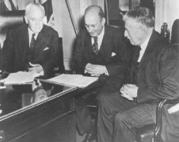 Photo taken in Secretary of State Cordell Hull's office on the occasion of the third meeting of the War Refugee Board. Hull is at the left, Secretary of the Treasury Henry Morgenthau, Jr., is in the center, and Secretary of War Henry L. Stimson is at the right. Washington, DC, United States, March 21, 1944.