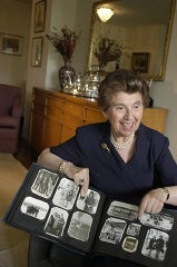 Regina Gelb displays an album of her prewar family photographs. 2004.