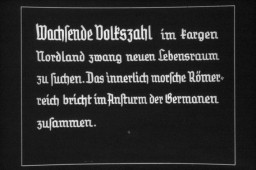 25th Nazi propaganda slide for a Hitler Youth educational presentation in the mid-1930s. The presentation was entitled "5000 years of German Culture." This slide references Lebensraum (the need for living space) in German history:  "Wachsende Volkszahl im fargen Nordland zwang neuen Lebensraum zu suchen. Das innerlich morsche Römerreich bricht im Ansturm der Germanen zusammen." Translated as:  "Growing numbers of people in Nordland were forced to look for a new habitat. The inwardly crumbling Roman Empire collapses with the German onslaught."