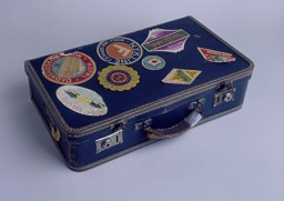 A suitcase used (ca. 1939) by a Jewish refugee fleeing Nazi-occupied Europe to Japan. The suitcase is covered with labels from various stops along the journey, including one from a hotel in Moscow (top left), one for the NYK Line (top middle), and six from hotels throughout Japan. [From the USHMM special exhibition Flight and Rescue.]