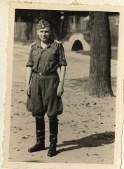 Photograph of Karl Höcker. He is standing in front of an air raid shelter.
From Karl Höcker's photograph album, which includes both documentation of official visits and ceremonies at Auschwitz as well as more personal photographs depicting the many social activities that he and other members of the Auschwitz camp staff enjoyed. These rare images show Nazis singing, hunting, and even trimming a Christmas tree. They provide a chilling contrast to the photographs of thousands of Hungarian Jews deported to Auschwitz at the same time. 