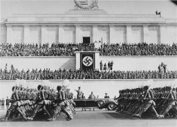 Reich Labor Service battalions parade before Hitler during the Nazi Party Congress. [LCID: 85504]