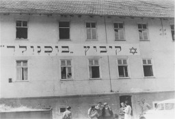 Jewish refugees in front of the "Kibbutz Buchenwald" building, where Jews received agricultural training in preparation for life ... [LCID: 30118]