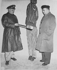 During an inspection by US Army chaplains of the newly liberated Buchenwald concentration camp, G. Bromley Oxnam (right) views a demonstration of how prisoners were tortured in Buchenwald. Oxnam was the Methodist bishop of New York and President of the Federated Council of Churches of Christ in America. Buchenwald, Germany, April 27, 1945.