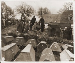 German civilians from Volary attend burial services for the Jewish women exhumed from a mass grave in the town. The victims died at the end of a death march from Helmbrechts, a subcamp of Flossenbürg. Germans were forced to exhume them in order to give the victims proper burial. Volary, Czechoslovakia, May 11, 1945.
