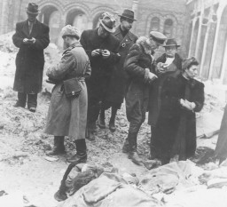 Families and friends of Jewish victims killed in the Budapest ghetto search for the exhumed corpses of friends and relatives. [LCID: 68618]