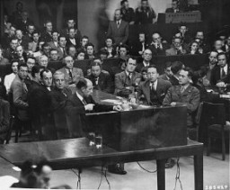 The prosecution team on the day the court announced its findings at the Milch Trial. Seated at the right is US Brigadier General Telford Taylor, chief of counsel. Across from him sits Clark Denny, chief trial counsel. April 16, 1947.