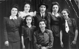 Group portrait of members of  the Katz family of Munkacs.
Pictured in the top row from left to right are: Chicha, Isabella, Philip, Jolon (Cipi), and Regina. In the bottom row are Helen (left) and Tereza. Munkacs, 1942–1943.