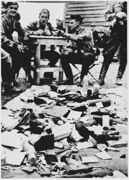 Ustasa (Croatian fascist) guards alongside belongings of prisoners at the Jasenovac concentration camp. [LCID: 68290b]