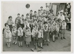 Austrian Jewish children being transported to the United States by Eleanor and Gilbert Kraus perform a life jacket drill aboard the ship President Harding. June 1939.