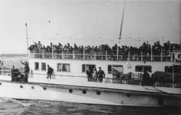 Thracian Jews crowd the upper deck of a deportation ship as it leaves the port of Lom. [LCID: 79719]