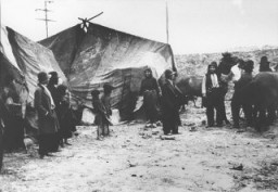 Scene from a Romani (Gypsy) camp: Roma (Gypsies) in front of their tents. Romania, 1936–40. (Bundesarchiv inventory number 146-2001-16-20A.)