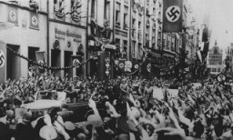 Saluting Germans greet Adolf Hitler (standing at front of car) as he enters Danzig. The Danzig District was incorporated into Greater Germany following the invasion of Poland. Danzig, September 19, 1939.