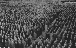Roll call for newly arrived prisoners, mostly Jews arrested during Kristallnacht (the "Night of Broken Glass" pogrom), at the Buchenwald concentration camp. Buchenwald, Germany, 1938.