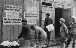 Jewish displaced persons put up signs demanding open immigration into Palestine. [LCID: 64045]