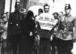 Public humiliation: "I am a defiler of the race." In this photograph, a young man who allegedly had illicit relations with a Jewish ... [LCID: 79267]