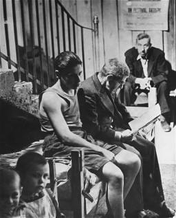 A man and his son, displaced persons (DPs) from Romania, wait on a cot in the Rothschild Hospital displaced persons camp in Vienna. [LCID: 43081]