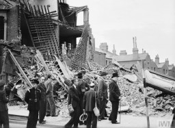 British Prime Minister Winston Churchill (far right) and others view buildings damaged during the Blitz. The Blitz was a German bombing campaign over Britain that lasted from September 7, 1940, to May 11, 1941. London, September 8, 1940. IWM(H 3978)