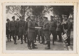 September 1, 1944, Richard Baer ceremonially accepts a copy of the construction plans from the Chief of the Central Construction ... [LCID: 34803]