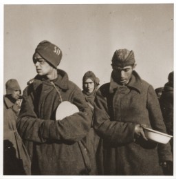 Soviet prisoners of war wait for food in Stalag (prison camp) 8C. [LCID: 50193]