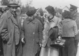 Eliahu Dobkin of the Jewish Agency (left) and Henrietta Szold, founder of the Hadassah Women's Zionist Organization (second from left), await the arrival of the "Tehran Children." Atlit, Palestine, February 18, 1943.