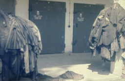 Prisoners' clothing and uniforms are piled in front of the doors to the crematoria in the newly liberated Dachau concentration camp