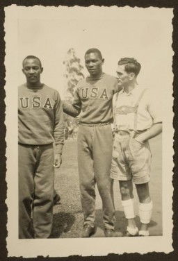 African American athletes Jesse Owens and Dave Albritton pose with a German citizen. They both competed in the 1936 Olympic Games. Albritton won the silver medal in high jump. Owens won gold medals in the 100-meter dash, 200-meter dash, broad (long) jump, and the 4x100-meter relay.