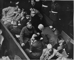 The defendants' box at the Nuremberg trial. Hermann Göring is seated at the far left of the first row. [LCID: 81920]