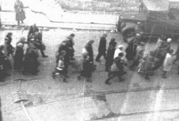 Deportation of Jews from the Warsaw ghetto during the uprising. This photo was taken secretly from a building adjacent to the ghetto by a Polish member of the resistance. Warsaw, Poland, April 1943.