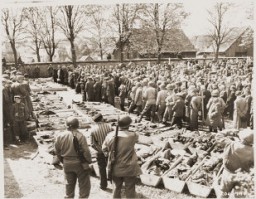 US troops and German civilians from Neunburg vorm Wald attend a funeral service for Polish, Hungarian, and Russian Jews found in the forest near their town. The victims were shot by the SS while on a death march from Flossenbürg. Neunburg, Germany, April 29, 1945.
Following the discovery of death march victims, US Army officers forced local Germans to view the scene of the crime and ordered the townspeople to give the victims a proper burial. 