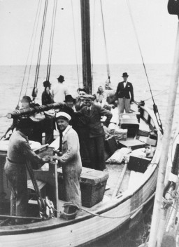 Danish fishermen (foreground) ferry Jews across a narrow sound to safety in neutral Sweden during the German occupation of Denmark. [LCID: 70737]