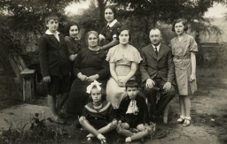 The Kracowski family was living in Bialystok when German Order Police Battalion 309 killed 2,000-3,000 Jews on June 27, 1941. Dr. Samuel Kracowski was among the hundreds of Jews locked in the Great Synagogue and burned alive. After the Germans ordered the establishment of a ghetto in Bialystok, Samuel's wife, Esther, and children, Ewa and Julek, were given a room in the ghetto clinic. Photo dated September 1, 1935.
Samuel and Esther are seated in the center, with Julek seated in the front row on the right. Ewa is on the far right, standing.  