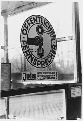 Sign on a phone booth in Munich that prohibits Jews from using the public telephone. Munich, Germany, 1942.