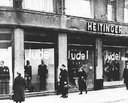 Windows of a Jewish-owned store painted with the word Jude (Jew). Berlin, Germany, June 19, 1938.