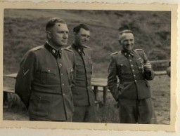 Richard Baer, Dr. Josef Mengele, and Rudolf Höss.
From Karl Höcker's photograph album, which includes both documentation of official visits and ceremonies at Auschwitz as well as more personal photographs depicting the many social activities that he and other members of the Auschwitz camp staff enjoyed. These rare images show Nazis singing, hunting, and even trimming a Christmas tree. They provide a chilling contrast to the photographs of thousands of Hungarian Jews deported to Auschwitz at the same time. 