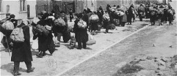 <p>Jews carrying their possessions during deportation to the <a href="/narrative/3852">Chelmno</a> killing center. Most of the people seen here had previously been deported to Lodz from central Europe. Lodz, Poland, January–April 1942.</p>