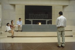 Visitors view the eternal flame in the Hall of Remembrance at the United States Holocaust Memorial Museum.