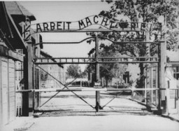 View of the main entrance to the Auschwitz camp: "Arbeit Macht Frei" (Work makes one free). [LCID: 0001]