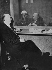 Among the many ironies of the International Military Tribunal was that the defendants were accorded that which they had denied their opponents: the protection of the law and a right to due process. Here, defendant Walther Funk, former German Minister of Economics, speaks with his defense attorney, Dr. Fritz Sauter, in a visitation room at Nuremberg.
