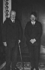 Reich President Paul von Hindenburg poses with Chancellor Adolf Hitler. Hindenburg appointed Hitler chancellor on January 30, 1933. Germany, 1933-1934.