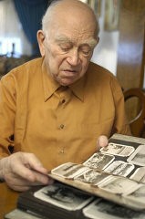 Norman Salsitz looks through his prewar family photographs. 2004.
With the end of World War II and collapse of the Nazi regime, survivors of the Holocaust faced the daunting task of rebuilding their lives. With little in the way of financial resources and few, if any, surviving family members, most eventually emigrated from Europe to start their lives again. Between 1945 and 1952, more than 80,000 Holocaust survivors immigrated to the United States. Norman was one of them. 
