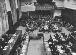 El Brigadier General Telford Taylor de los EE.UU., abogado jefe, para los crímenes de guerra, abre el juicio de los ministerios por leyendo la acusación inicial. Él acusa a los ministros de Hitler de "crímenes contra la humanidad." Nuremberg, Alemania, el 6 de enero de 1948.