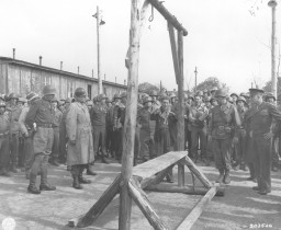 A Dutch survivor of the Ohrdruf camp shows the camp's gallows, which the Germans used to execute prisoners, to US forces (including ... [LCID: 74981]