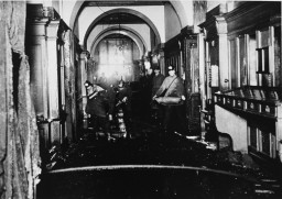 Several firemen working in a large hallway of the Reichstag (parliament building) after the fire was extinguished.