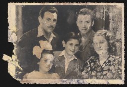 Bust-length portrait of three adults and two children with light skin tones.