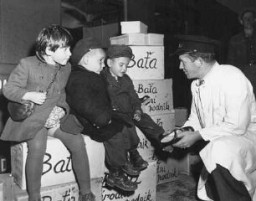 Jewish orphans after the Holocaust are fitted with shoes from the United Nations Relief and Rehabilitation Administration (UNRRA), en route to Allied occupation zones in Germany and Austria. Prague, Czechoslovakia, August 25, 1946.